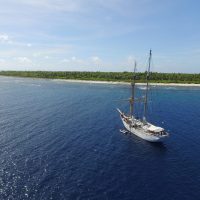 Drone image of the Seamans alongside Nikumaroro.