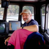 At the helm of the R/V Centennial