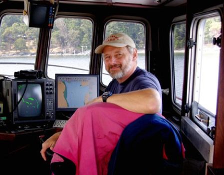 At the helm of the R/V Centennial
