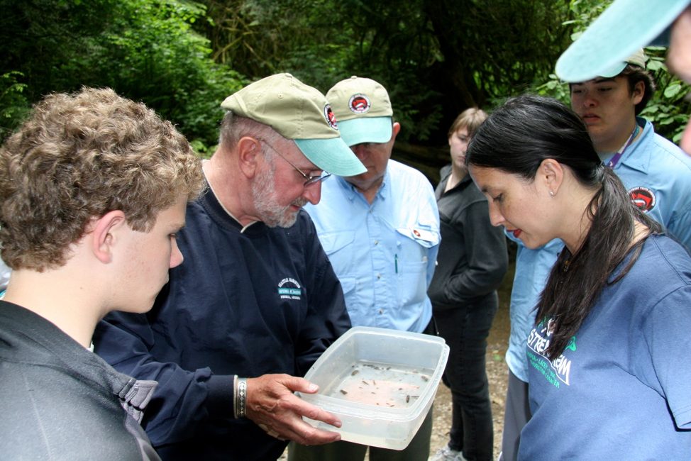 Jim Karr and students at the Northwest Youth Conservation and Fly Fishing Academy, 2008, examining bugs from MacLean Creek in Capitol State Forest.