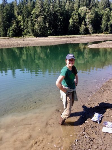 Julia Indivero standing by a lake in the mountains