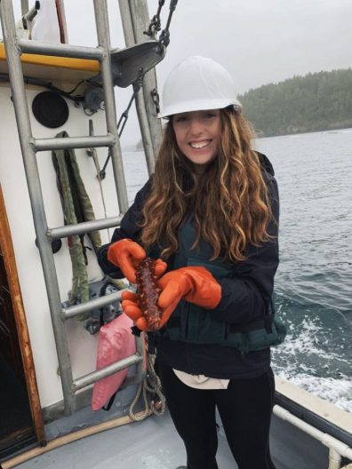 Ruth holding a sea cucumber on a research cruise out of Friday Harbor Laboratory.