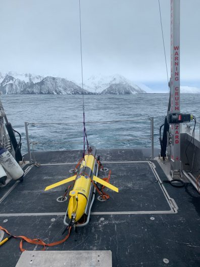 Glider on the back of a ship being prepared for launch in the ocean