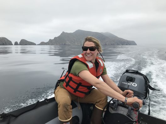 Amelia DuVall driving a boat.