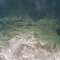 Aerial view of an oyster farm in the water.