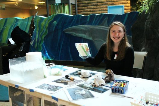 Jenny Stern sits at a table in a museum while volunteering.