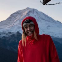 Claire Vaage stands in front of a mountain