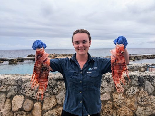 Sarah holds two lionfish.