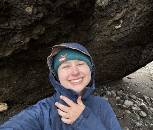Iris Haley takes a selfie on a beach.