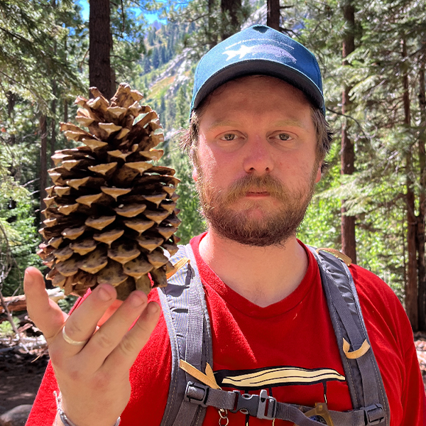 Connor whalen, holding a pine cone